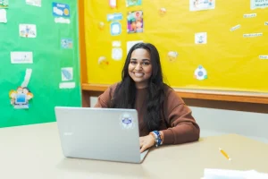 Student sitting at desk with computer