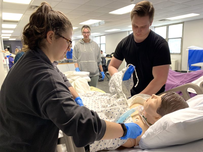 Male and female student in sim lab