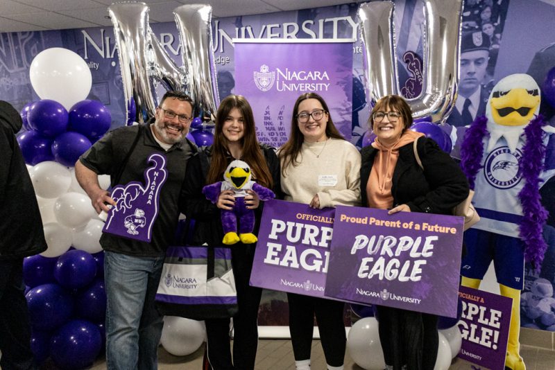 Family holding sign at Accepted Student day event at Niagara University.