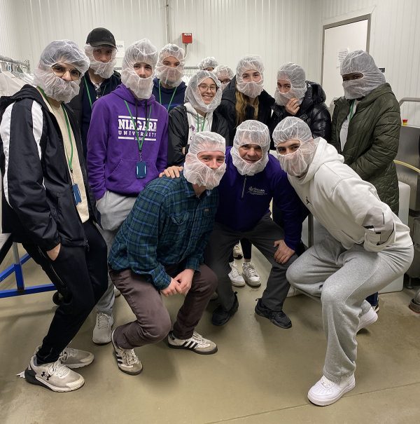 Students putting on protective gear before going into the rosina factory