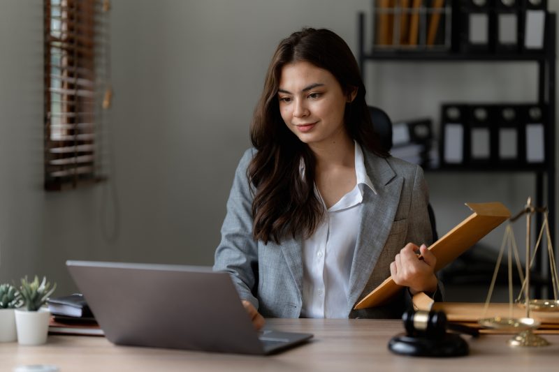 Lawyer business woman working or reading agreement contract in office workplace for consultant lawyer concept.