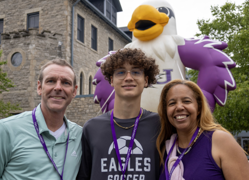 family standing in front of inflatable monte