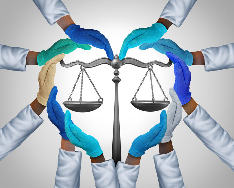 Medical laws and legal medicine or malpractice law as a group of hospital workers or doctor and nurse hands holding a justice scale as a health legislation symbol with 3D illustration elements.