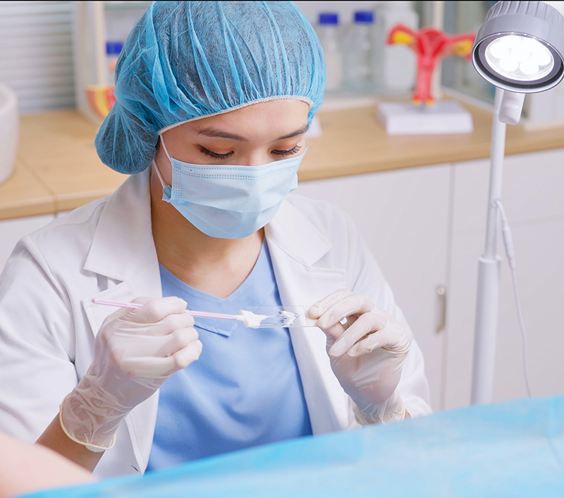 female nurse collecting samples and putting them on a slide